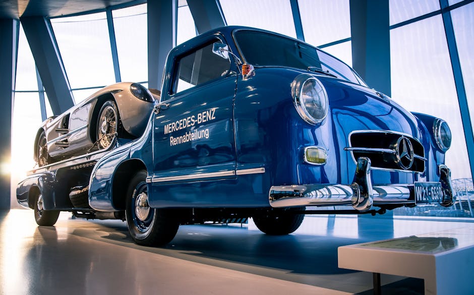Vintage Mercedes-Benz racing truck displayed indoors in a modern showroom setting.