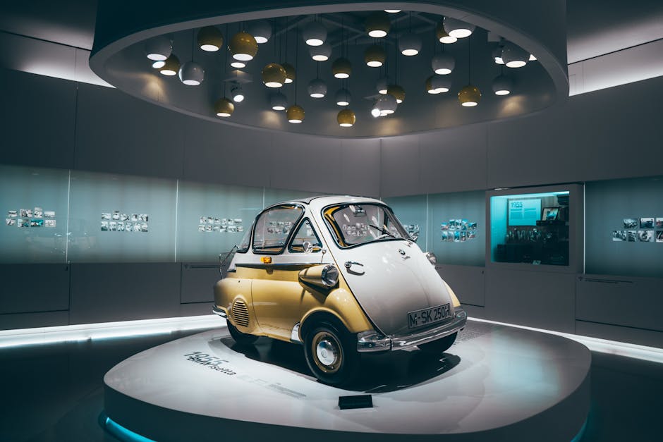 A classic microcar showcased in a modern, illuminated Munich showroom, highlighting luxury design.